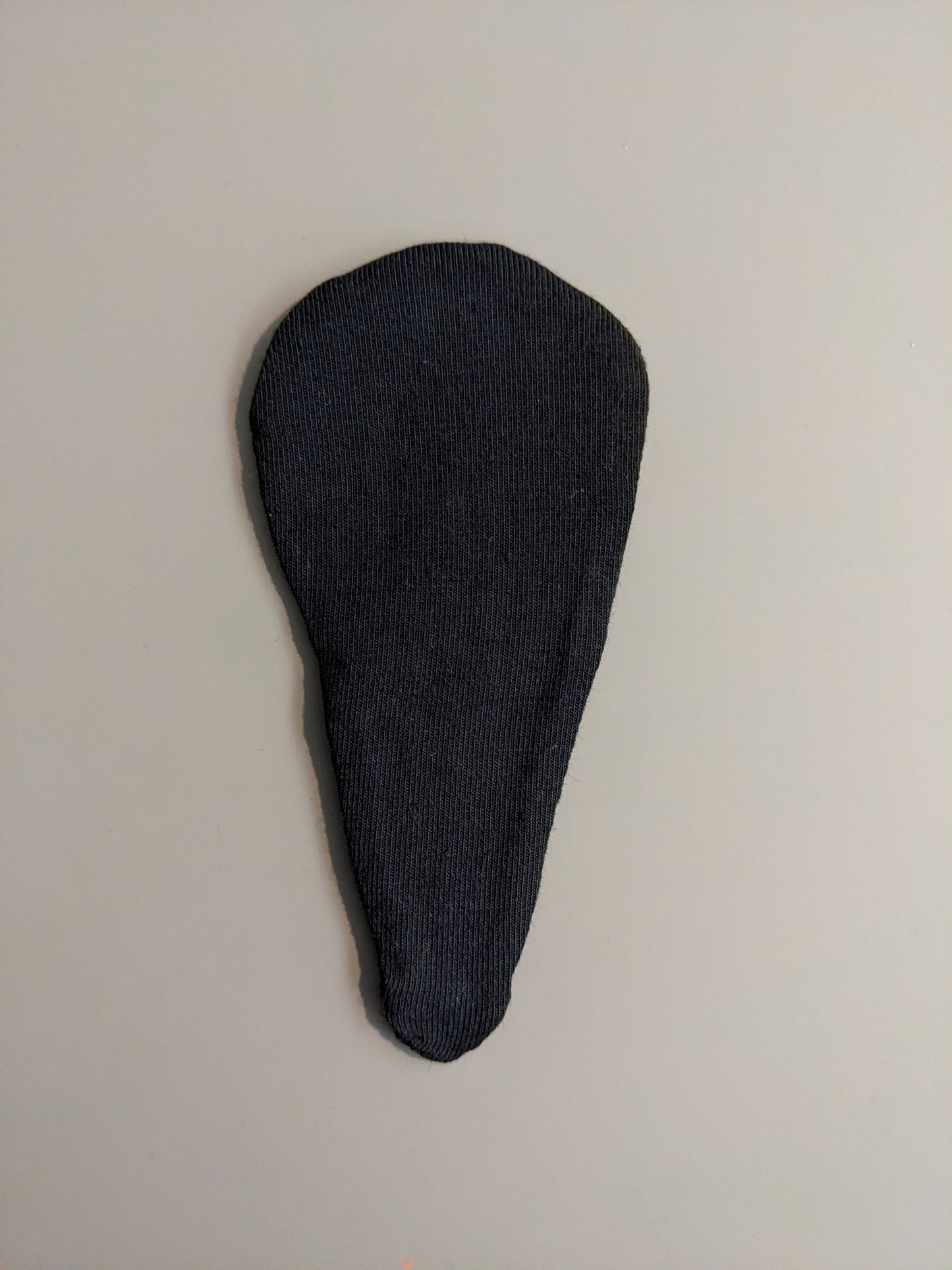 Black detachable liner against plain background