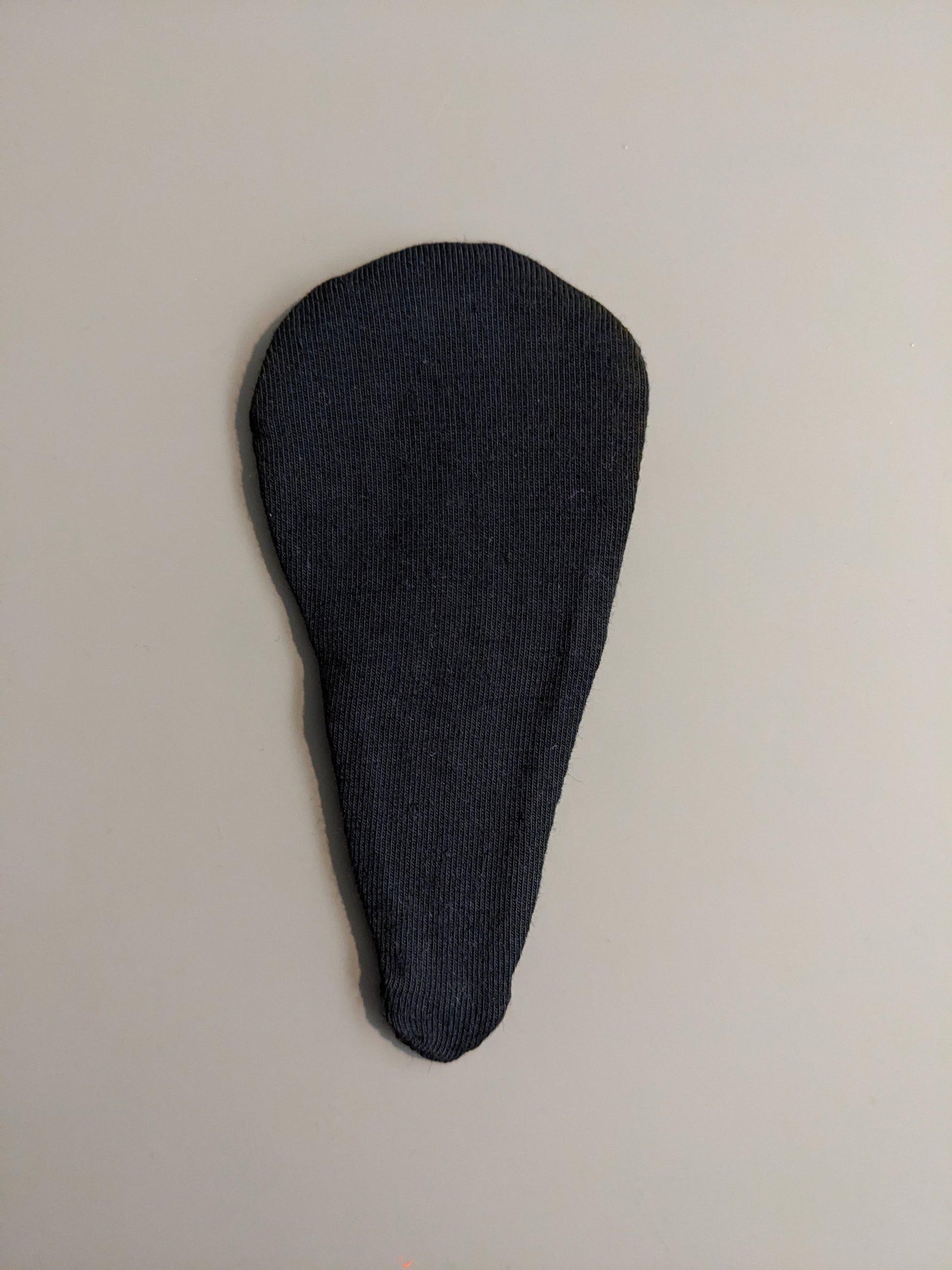 Black detachable liner against plain background